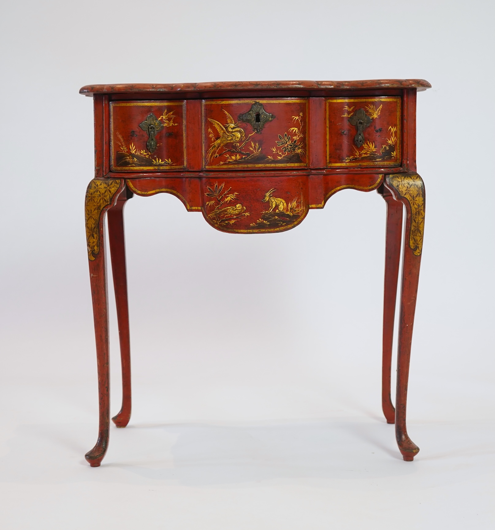 An early 18th century scarlet japanned lowboy